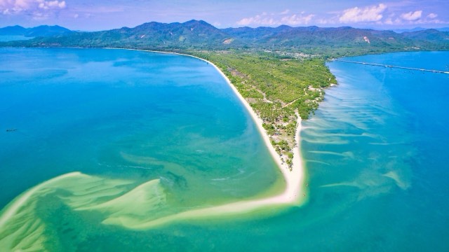 Aerial view of a white sand spit curling into turquoise water off Ko Yao Yai