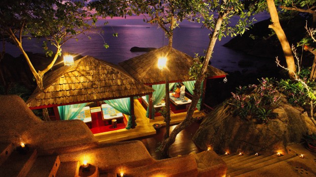 Candle-lit open-air spa pavilions in the evening on Ko Samui